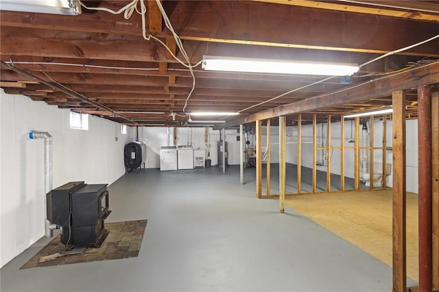 41 Valley View Dr, Cumberland, RI 02864 - basement with oil tank, washing machine and dryer, a wood stove, and water heater