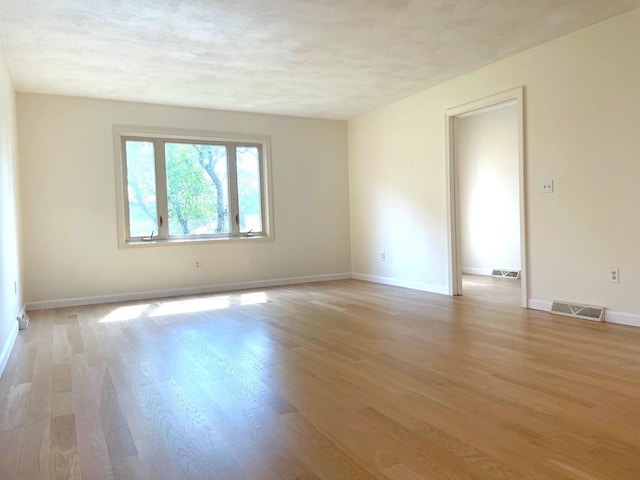 141 Sturbridge Dr, Warwick, RI 02886 - empty room featuring light wood finished floors and a textured ceiling