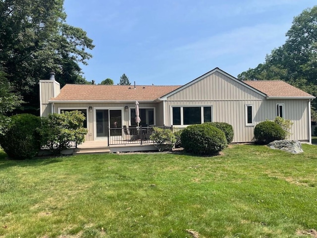 141 Sturbridge Dr, Warwick, RI 02886 - rear view of property with a chimney, a wooden deck, a yard, and roof with shingles