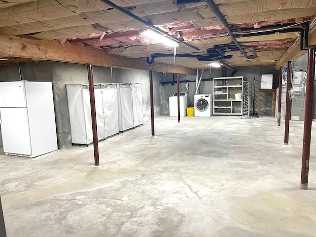 141 Sturbridge Dr, Warwick, RI 02886 - unfinished basement with freestanding refrigerator, washer / clothes dryer, and heating unit