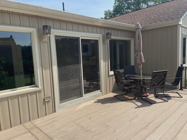 141 Sturbridge Dr, Warwick, RI 02886 - wooden terrace with outdoor dining area and french doors