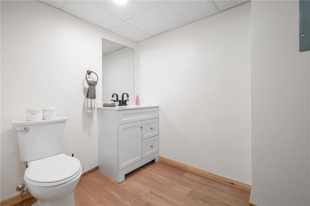607 Knollwood Dr, Woonsocket, RI 02895 - half bath featuring vanity, wood finished floors, and a drop ceiling
