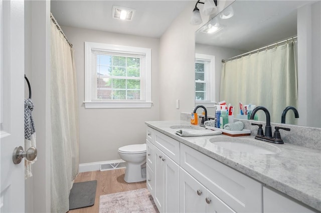 607 Knollwood Dr, Woonsocket, RI 02895 - full bath with double vanity, wood finished floors, and a shower with curtain