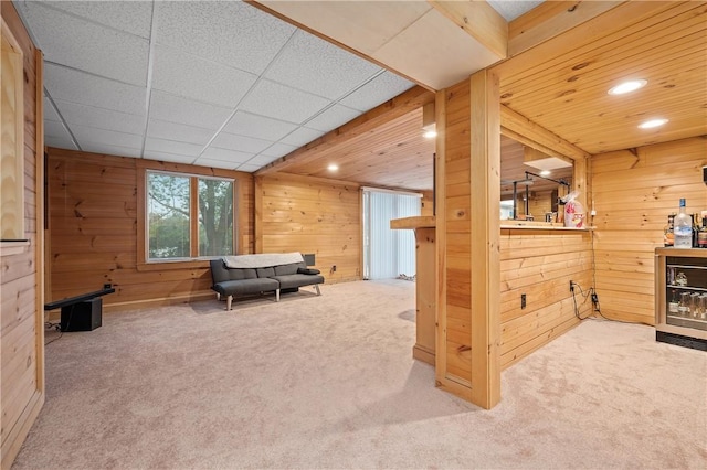 607 Knollwood Dr, Woonsocket, RI 02895 - sitting room featuring wood walls, carpet flooring, recessed lighting, and beverage cooler