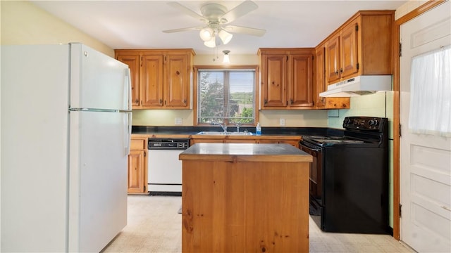 92 Glendale Dr, West Warwick, RI 02893 - kitchen featuring white appliances, under cabinet range hood, light flooring, a center island, and ceiling fan