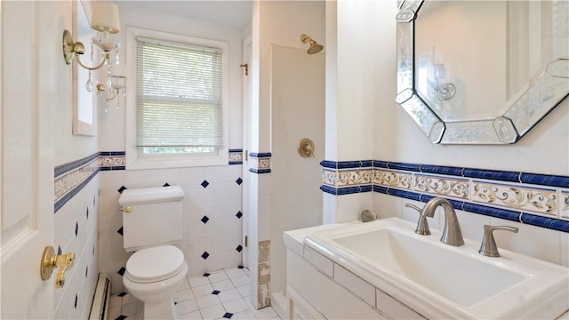 92 Glendale Dr, West Warwick, RI 02893 - bathroom with tile walls, healthy amount of natural light, tile patterned floors, a baseboard heating unit, and wainscoting