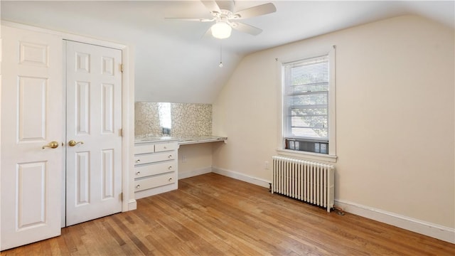 92 Glendale Dr, West Warwick, RI 02893 - bonus room with radiator, lofted ceiling, built in study area, ceiling fan, and light wood-style flooring