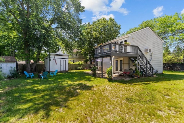 4 Clarke St, Warwick, RI 02886 - rear view of property featuring a storage unit, a deck, french doors, an outdoor fire pit, and stairway