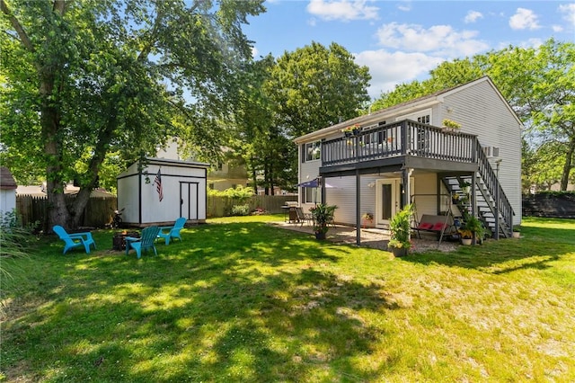 4 Clarke St, Warwick, RI 02886 - back of house with stairs, a storage unit, a deck, a fenced backyard, and a patio