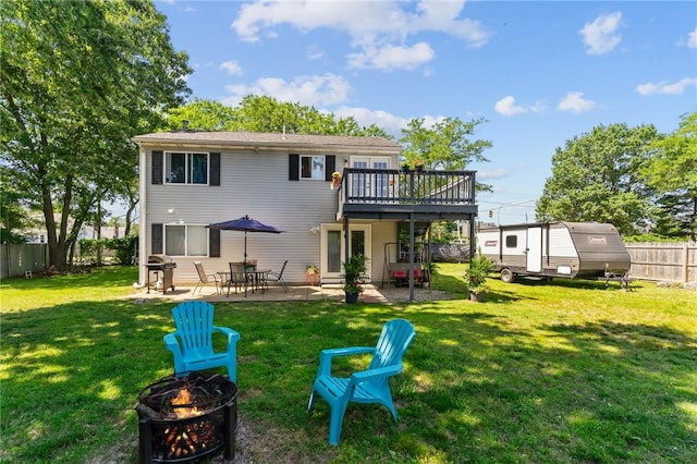 4 Clarke St, Warwick, RI 02886 - rear view of property featuring a fire pit, a deck, a fenced backyard, and a patio area
