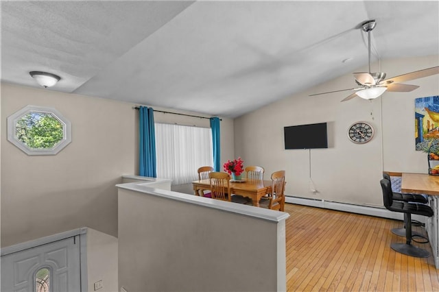 4 Clarke St, Warwick, RI 02886 - dining room featuring a baseboard radiator, lofted ceiling, hardwood / wood-style flooring, ceiling fan, and an office area