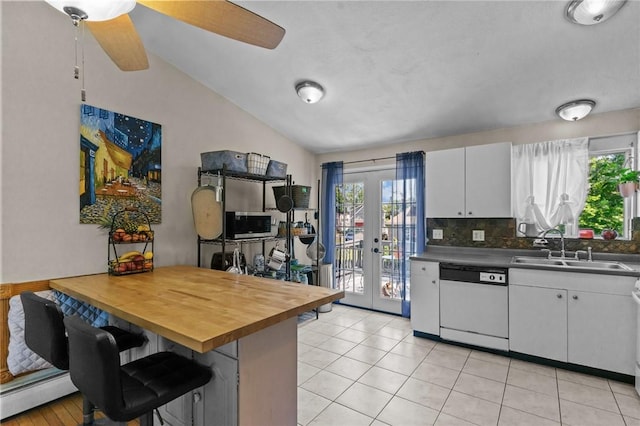 4 Clarke St, Warwick, RI 02886 - kitchen featuring white dishwasher, a baseboard heating unit, french doors, white cabinets, and lofted ceiling
