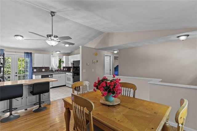 4 Clarke St, Warwick, RI 02886 - dining area with lofted ceiling, a ceiling fan, light wood finished floors, and french doors