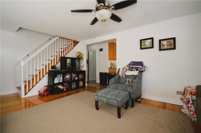 27 Observatory Rd, Warwick, RI 02888 - sitting room with stairway, a ceiling fan, and wood finished floors