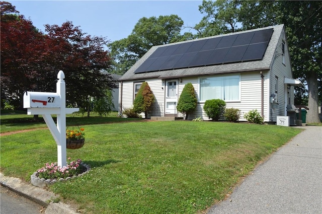 27 Observatory Rd, Warwick, RI 02888 - view of front facade featuring roof mounted solar panels, a front lawn, and roof with shingles