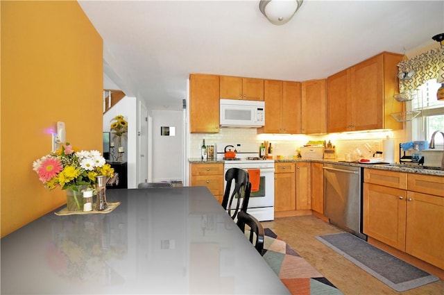 27 Observatory Rd, Warwick, RI 02888 - kitchen with white appliances, backsplash, and brown cabinetry