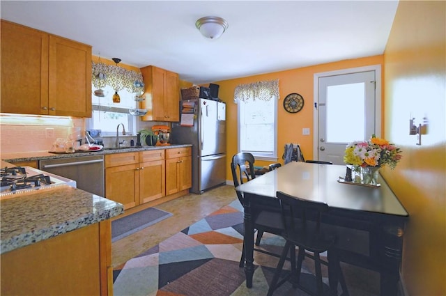 27 Observatory Rd, Warwick, RI 02888 - kitchen with stainless steel appliances, plenty of natural light, and brown cabinets