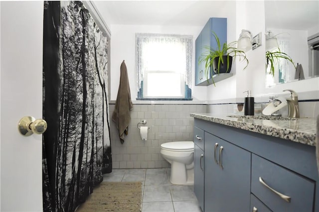 27 Observatory Rd, Warwick, RI 02888 - bathroom with tile patterned flooring, tile walls, vanity, and wainscoting