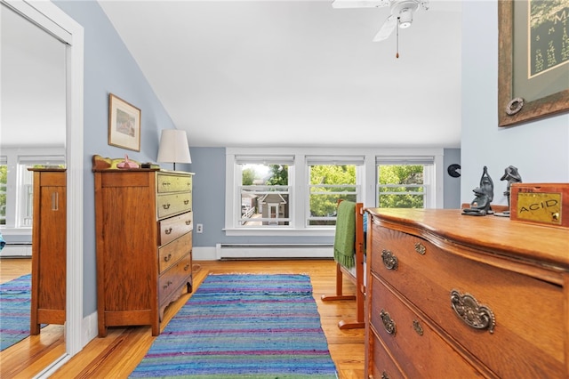 161 Ferncrest Ave, Cranston, RI 02905 - bedroom with a baseboard heating unit, vaulted ceiling, multiple windows, light wood-style flooring, and a ceiling fan