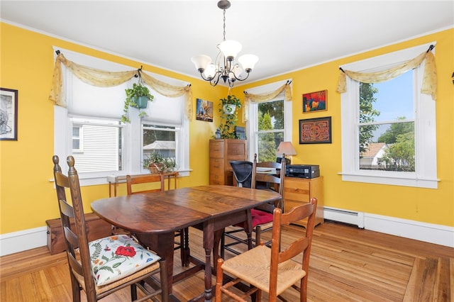 161 Ferncrest Ave, Cranston, RI 02905 - dining space featuring a chandelier, wood finished floors, crown molding, and a baseboard radiator