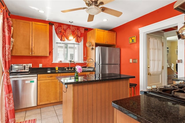 161 Ferncrest Ave, Cranston, RI 02905 - kitchen with appliances with stainless steel finishes, a ceiling fan, a kitchen island, light tile patterned floors, and recessed lighting