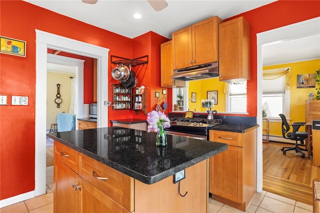 161 Ferncrest Ave, Cranston, RI 02905 - kitchen with under cabinet range hood, stainless steel range with gas stovetop, light tile patterned floors, a baseboard radiator, and recessed lighting