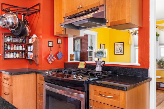 161 Ferncrest Ave, Cranston, RI 02905 - kitchen with under cabinet range hood, stainless steel gas range, dark countertops, and brown cabinets