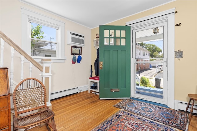 161 Ferncrest Ave, Cranston, RI 02905 - foyer entrance with a baseboard heating unit, wood finished floors, an AC wall unit, healthy amount of natural light, and crown molding
