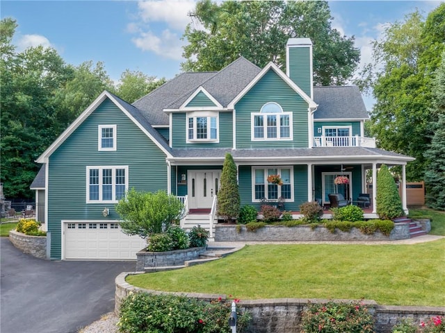 2 Medinah Dr, West Warwick, RI 02893 - view of front of property featuring a chimney, covered porch, driveway, an attached garage, and a front lawn