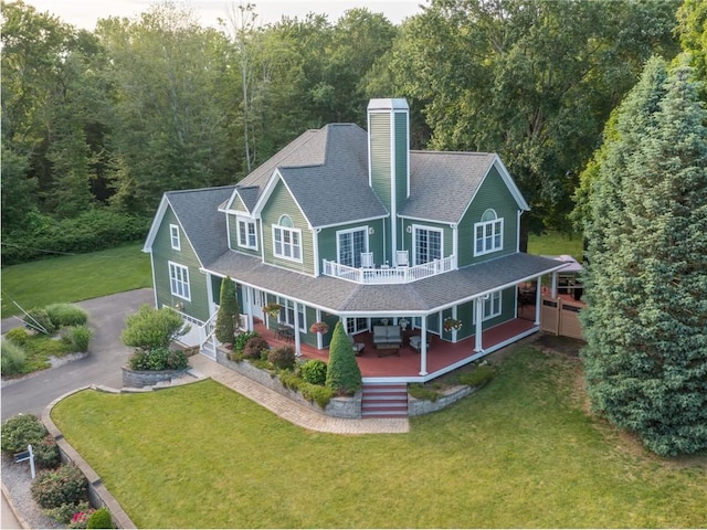 2 Medinah Dr, West Warwick, RI 02893 - rear view of house with roof with shingles, a lawn, a chimney, asphalt driveway, and covered porch