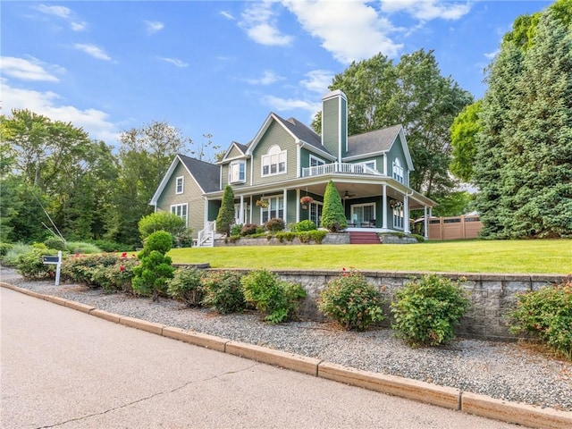 2 Medinah Dr, West Warwick, RI 02893 - view of front of house featuring covered porch, a chimney, and a front lawn