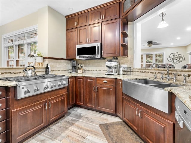 2 Medinah Dr, West Warwick, RI 02893 - kitchen with appliances with stainless steel finishes, decorative backsplash, a ceiling fan, recessed lighting, and light stone countertops