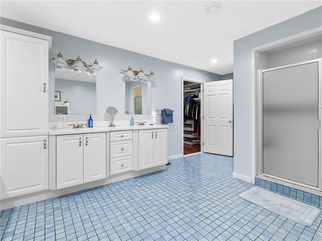 2 Medinah Dr, West Warwick, RI 02893 - bathroom featuring a shower stall, double vanity, a walk in closet, and recessed lighting