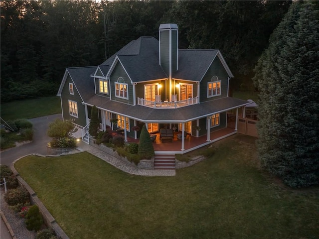 2 Medinah Dr, West Warwick, RI 02893 - rear view of house featuring a porch, a chimney, asphalt driveway, a lawn, and a balcony