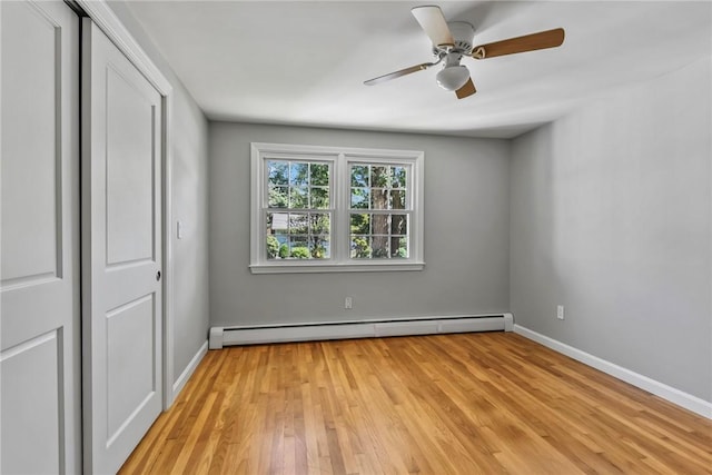 88 Grand View Rd, East Greenwich, RI 02818 - unfurnished bedroom featuring baseboard heating, light wood-type flooring, a closet, and ceiling fan