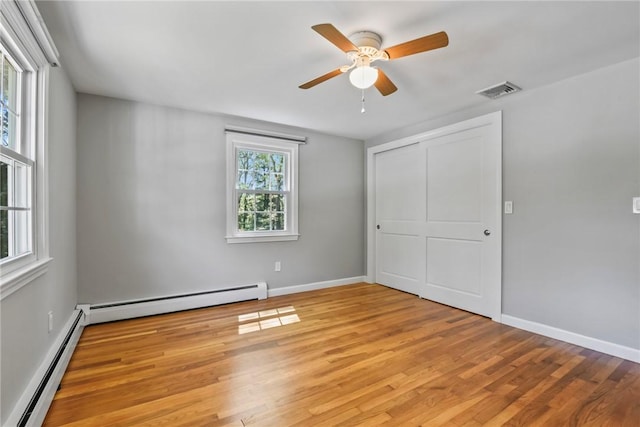 88 Grand View Rd, East Greenwich, RI 02818 - unfurnished bedroom featuring a baseboard radiator, light wood-type flooring, a closet, and ceiling fan
