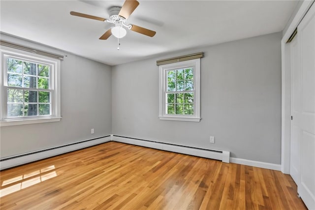 88 Grand View Rd, East Greenwich, RI 02818 - unfurnished bedroom featuring baseboard heating, a closet, wood finished floors, and ceiling fan