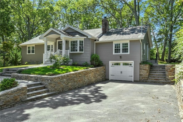 88 Grand View Rd, East Greenwich, RI 02818 - ranch-style home with a garage, driveway, a chimney, stairway, and a shingled roof