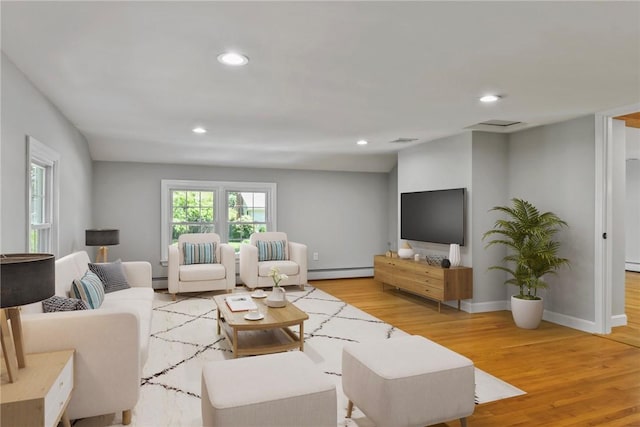 88 Grand View Rd, East Greenwich, RI 02818 - living area with baseboard heating, light wood-type flooring, recessed lighting, and a baseboard radiator