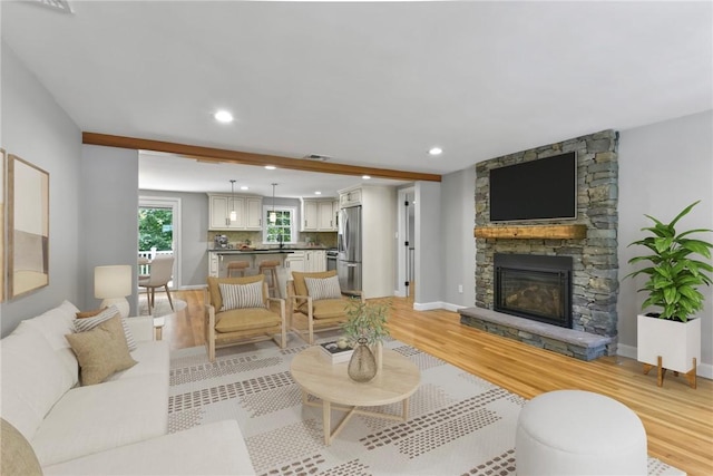 88 Grand View Rd, East Greenwich, RI 02818 - living area featuring light wood-style floors, a stone fireplace, and recessed lighting