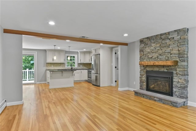 88 Grand View Rd, East Greenwich, RI 02818 - unfurnished living room with light wood finished floors, plenty of natural light, a fireplace, recessed lighting, and baseboard heating