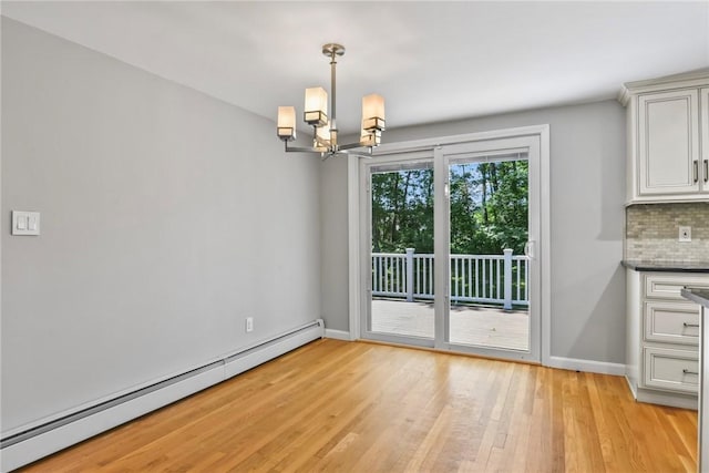 88 Grand View Rd, East Greenwich, RI 02818 - unfurnished dining area with baseboard heating, a chandelier, and light wood finished floors