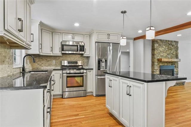 88 Grand View Rd, East Greenwich, RI 02818 - kitchen with appliances with stainless steel finishes, dark countertops, light wood finished floors, decorative backsplash, and recessed lighting