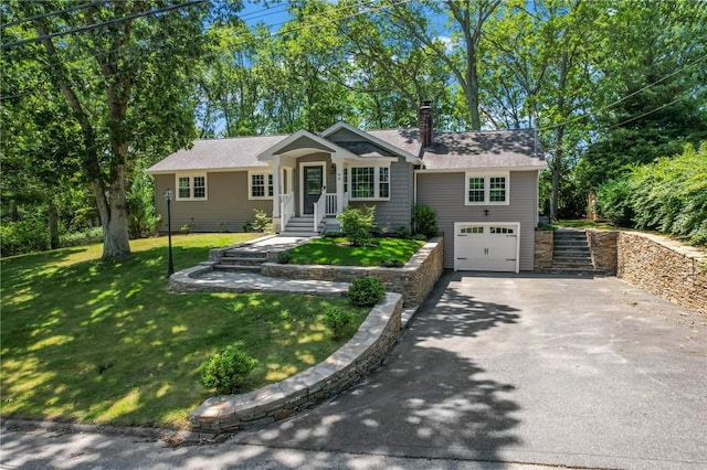 88 Grand View Rd, East Greenwich, RI 02818 - single story home with asphalt driveway, an attached garage, a chimney, a front lawn, and roof with shingles