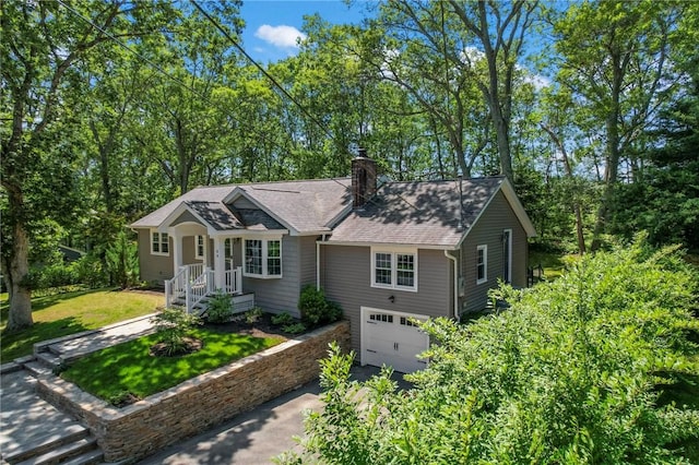 88 Grand View Rd, East Greenwich, RI 02818 - view of front of home with driveway, a garage, a chimney, roof with shingles, and a front yard