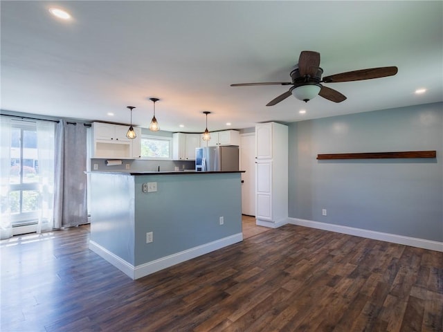 69 Haverhill Ave, Warwick, RI 02886 - kitchen with stainless steel refrigerator with ice dispenser, white cabinetry, recessed lighting, dark countertops, and ceiling fan