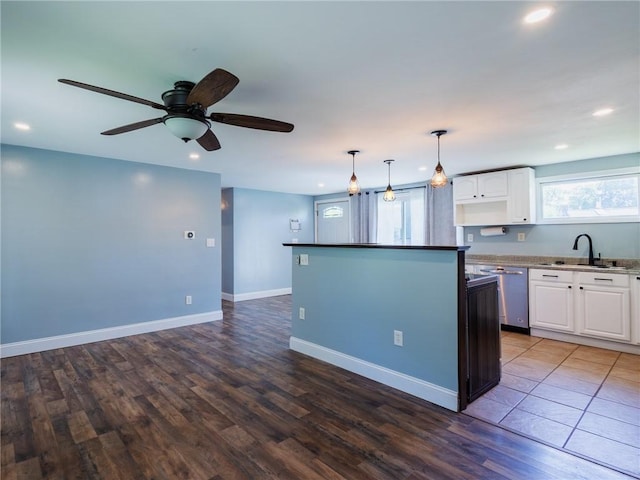 69 Haverhill Ave, Warwick, RI 02886 - kitchen with stainless steel dishwasher, white cabinetry, recessed lighting, wood finished floors, and a ceiling fan