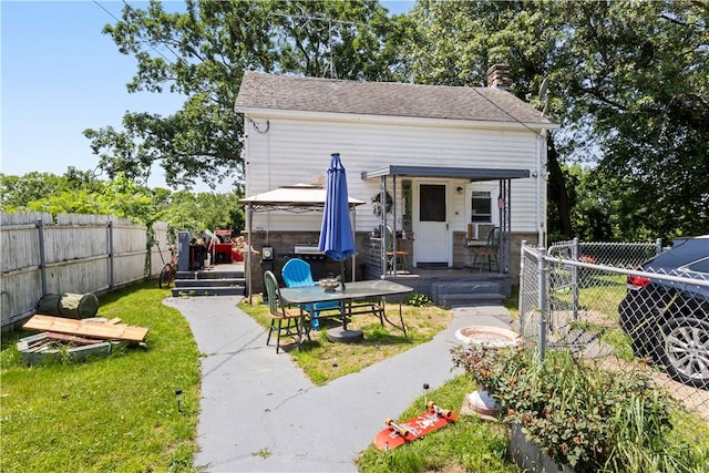 10 Sacramento St, Providence, RI 02909 - view of front of house with a gazebo, a fenced backyard, and a chimney