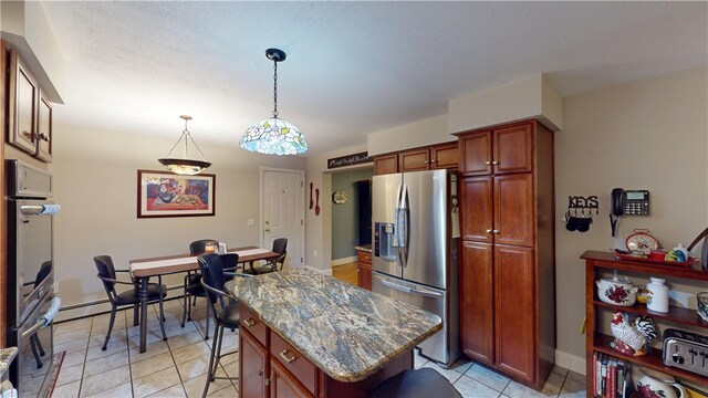 4 Tray Hollow Rd, Foster, RI 02825 - kitchen with stainless steel appliances, decorative light fixtures, dark stone counters, a kitchen island, and light tile patterned flooring
