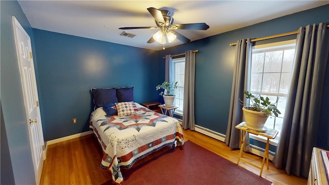 4 Tray Hollow Rd, Foster, RI 02825 - bedroom with a baseboard heating unit, multiple windows, wood finished floors, and a ceiling fan